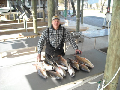 Capt Gene Dugas witha redfish dinner on the table