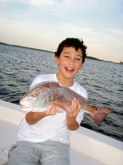 Eleven year old Jacob  is all smiles with a twenty-six inch redfish