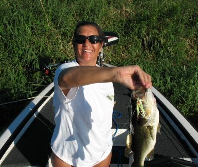 Julie H. catches a nice bass on a spinner